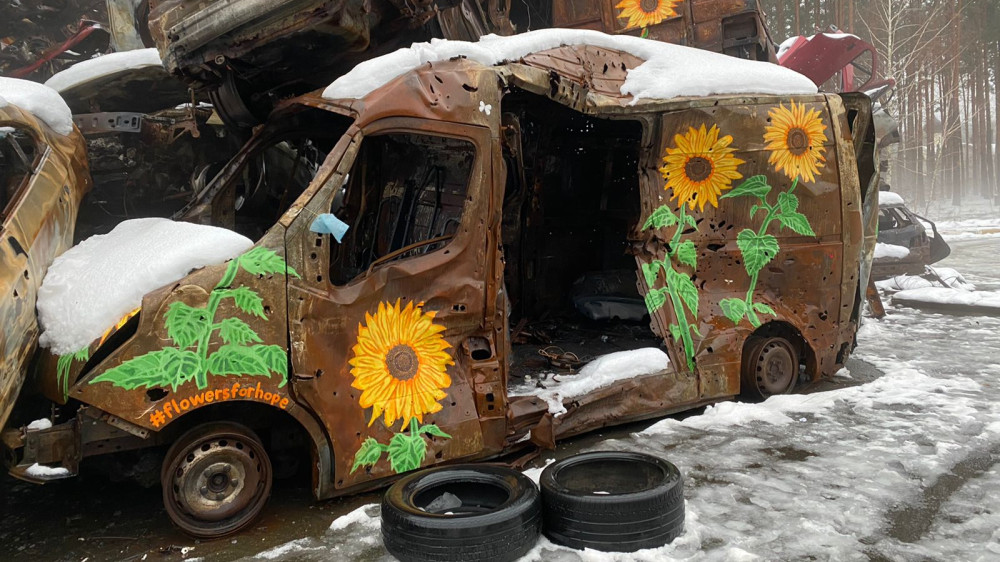 Sunflowers painted on destroyed cars